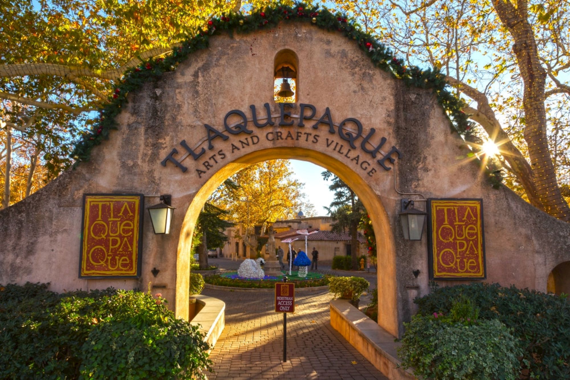 An arched entrance with the sign 